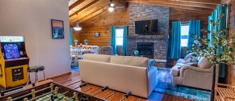 A log home with large living space to relax by the fireplace or play games