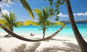 Relax in a hammock on our stunning beach – pure bliss under the palm trees.