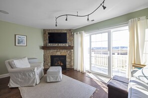 Living room with step out to deck, overlooking marsh