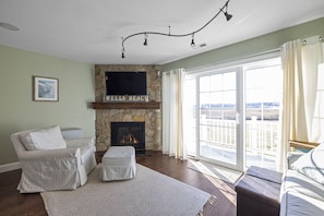 Living room with step out to deck, overlooking marsh