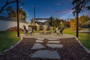 Massive smokeless fire pit with 2 comfy egg chairs, plenty of seating space, and firewood provided free from your host!