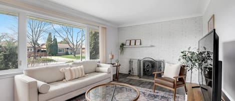 Relax in this cozy living room tons of natural light pouring in. 