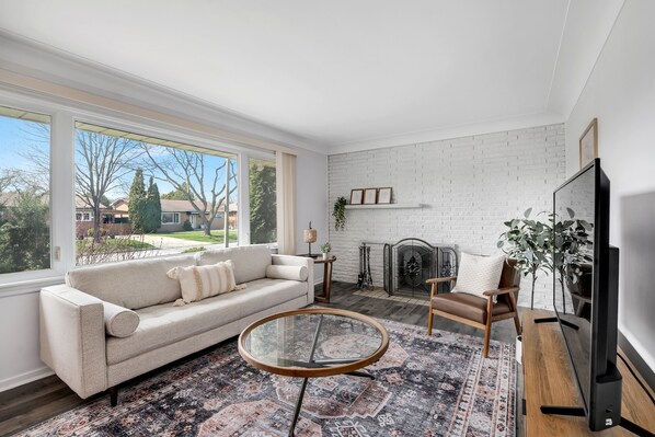 Relax in this cozy living room tons of natural light pouring in. 