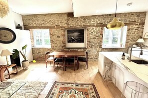 Open-plan kitchen dining are with high ceilings and stylish furnishings