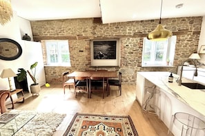 Open-plan kitchen dining are with high ceilings and stylish furnishings