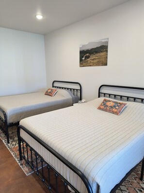 Leisure Suite - Equipped with Two Queen Beds, Kitchenette, 32-inch Smart TV, and, Dining Area.