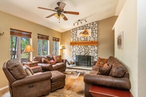 Living room with a wood burning fireplace. 