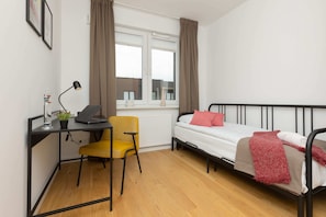 Bedroom featuring a desk and chair, combining comfort and functionality for work or study.
