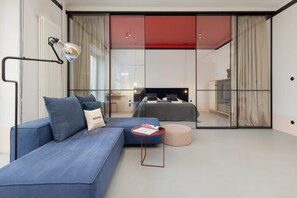 Stylish living area with a blue sectional sofa, matching cushions, and a minimalist coffee table for relaxation.
