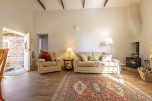 Sitting area with exposed beams and wood burning stove