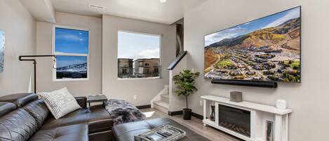 Silver Creek Village 6627: Cozy sofa set by window, big TV with impressive soundbar.