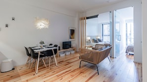 Feel right at home in our spacious living area, with a couch, dining area and TV for your entertainment #bright #airbnb #lovelystay