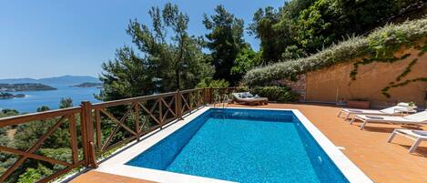 Villa Europa is a luxurious two-bedroom holiday rental property with a private pool, sea-facing balcony and veranda, located in the Skiathos Gea Villas complex on Katsaros hill, offering tranquility, stunning sea views, and easy access to the island's san