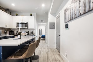 Full size kitchen with a bar for 3 people
