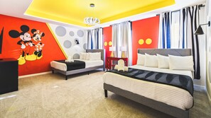 Playful Mickey Mouse-themed room with two full beds, creating a whimsical and delightful atmosphere.