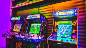 Arcade haven in Marvel decor, featuring games and pool table for epic gaming nights.