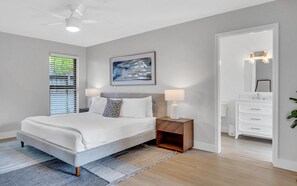 The master bedroom boasts a king size bed, access to the backyard, and a Smart T.V.