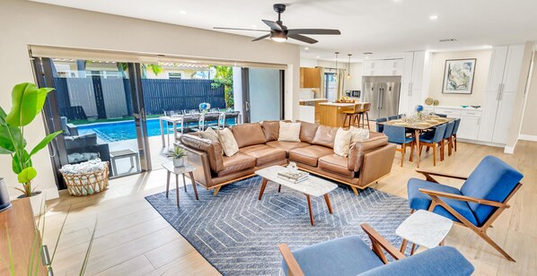 The living area has plenty of comfortable seating, giving everyone room to gather around the wall mounted Smart T.V.