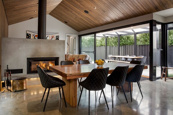 Host memorable dinners around the timber table for eight, where the double-sided fireplace and bold artwork set the perfect mood for lively conversations.