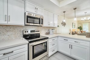 Kitchen with microwave, stove/oven, fridge, dishwasher, utensils etc