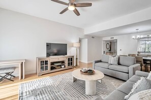 The living room also features a desk to offer some work space if needed