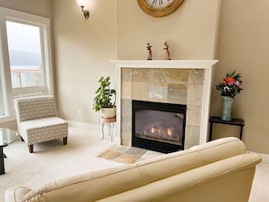 The living space has comfortable seating, fireplace and a fantastic view