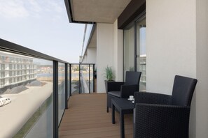 Balcony with outdoor furniture, providing a relaxing spot and a view of the surroundings.
