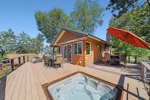 Take advantage of the outdoor spaces with covered patio seating, hot tub, fire pit and the sounds of pond.and nature.