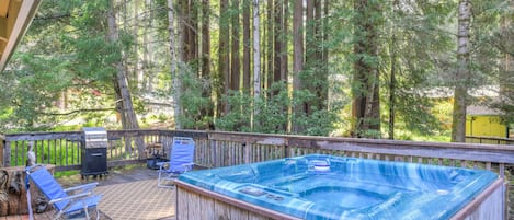 Hot tub with gas BBQ grill and lounge chairs