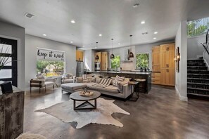 Open living room and kitchen with smart. TV and appliances