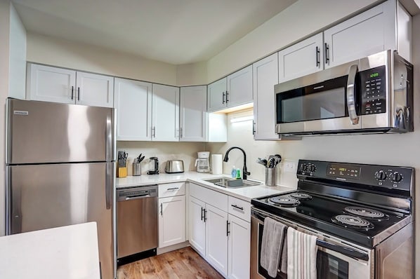 Kitchen has a dishwasher and stainless steel appliances.