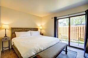 Bedroom has a king bed, two nightstands, a closet and clothing storage.