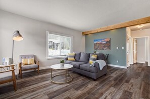 Discover the heart of our home - a living room designed for comfort and connection. Sink into the plush embrace of our inviting sofa and chairs, offering the perfect spot to unwind and recharge. Soft throws and cushions add an extra layer of coziness, making this space an ideal retreat after a day of adventure.