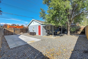Spacious backyard retreat with a BBQ grill, seating area, and plenty of space to relax and enjoy the fresh air.