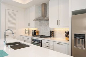 Massive island with all the cookware and plate-ware you’d need!
