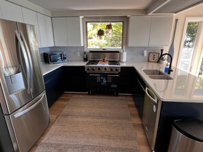 Kitchen with new fridge and air fryer/toaster oven/microwave combo