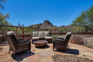 Backyard patio with fire pit looking out to Sombrero Peak