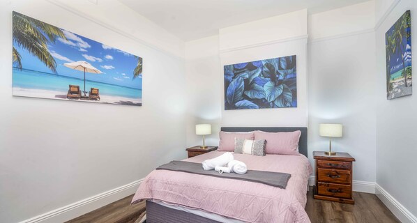 Main bedroom, looking out onto Summer street with built in wardrobe.
