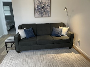 Living room sofa, footstool, lamp