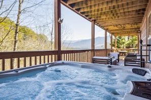 Soak in the hot tub while taking in breathtaking mountain views!