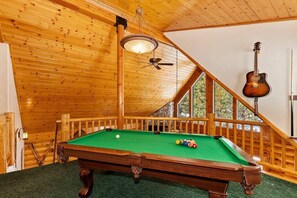Pool table in loft area. 