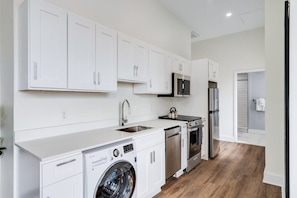 Enjoy making home-cooked meals or getting takeout in this lovely kitchen with stainless steel appliances and a full-size refrigerator