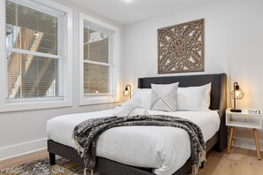 Comfortable bed with a white pillow in Washington DC apartment