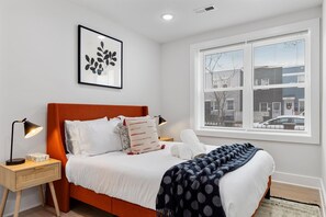 Cozy bedroom with bed and window in Washington DC apartment