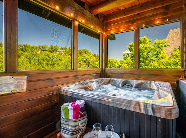 Enjoy a private outdoor hot tub on the screen-in porch!