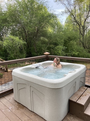 Private hot tub surrounded by green.  Leave your stress at home.