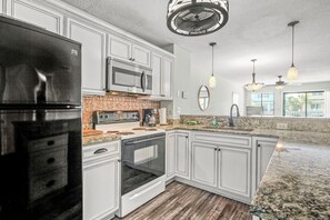 Fully stocked kitchen with granite counter tops.