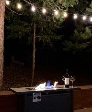 relax under the stars and sting lights, around the fire table, enjoy a drink