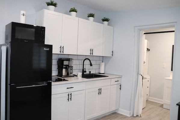 Kitchen with stove, Microwave, fridge and freezer, and Ninja Coffee maker.