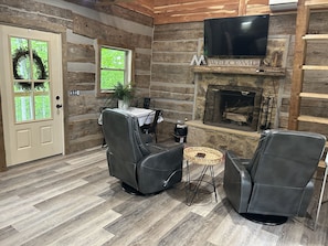 Open living room with fireplace and TV